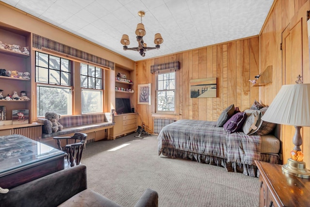 carpeted bedroom with wood walls and an inviting chandelier