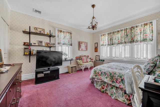 carpeted bedroom featuring crown molding, visible vents, a chandelier, baseboards, and wallpapered walls