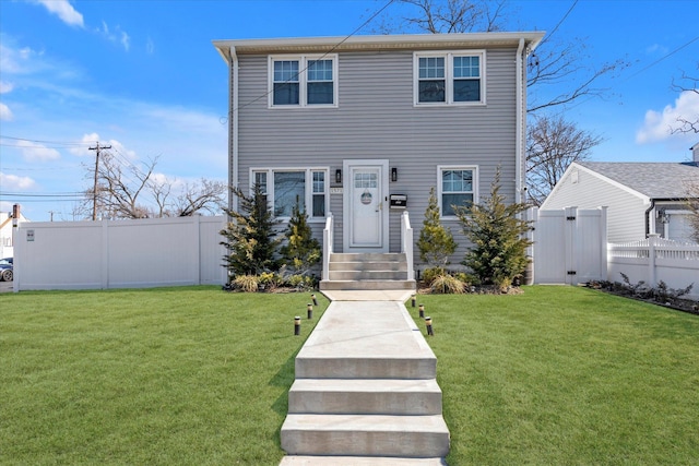 view of front of home with a front lawn and fence