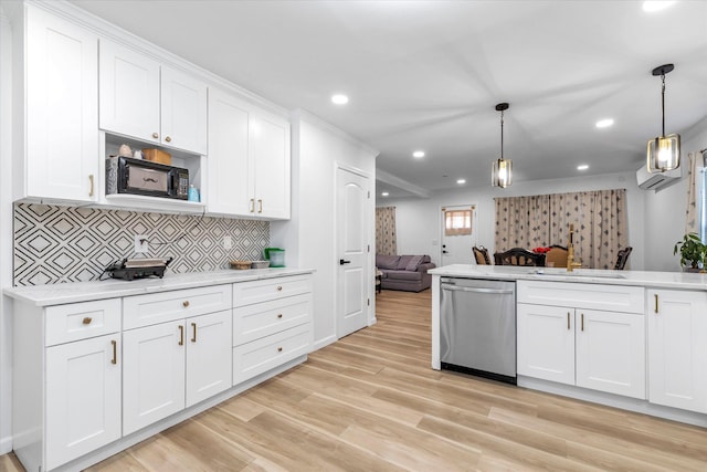 kitchen with light wood finished floors, light countertops, stainless steel dishwasher, open floor plan, and white cabinets