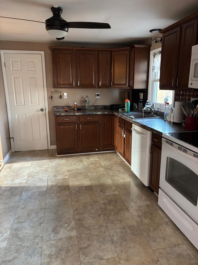 kitchen featuring white appliances and a sink