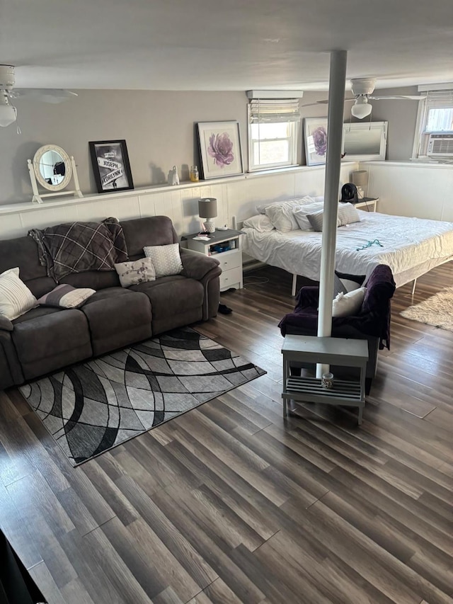 living room with cooling unit and wood finished floors