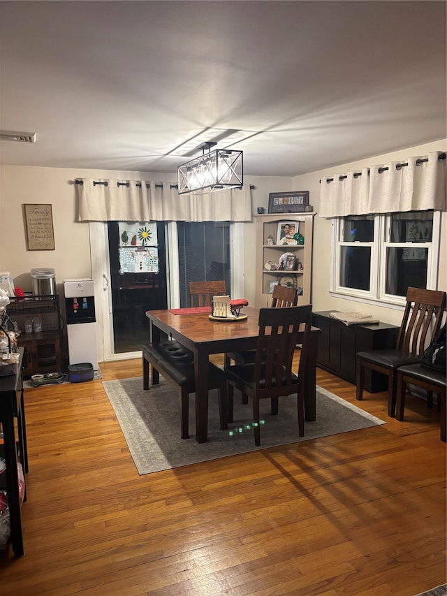 dining area featuring visible vents and hardwood / wood-style flooring