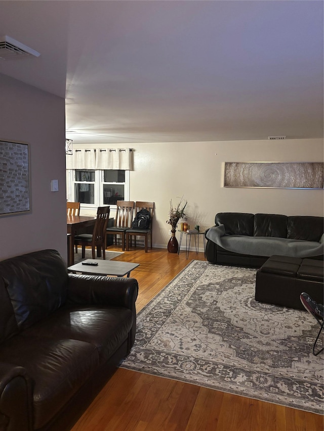 living area with wood finished floors and visible vents