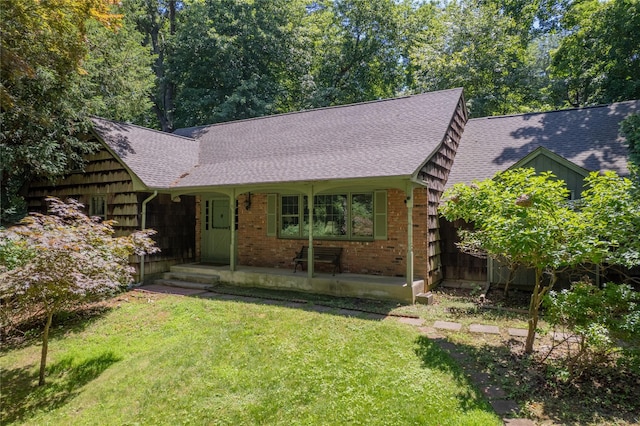 35 Mary Pitkin Path, Shoreham, NY 11786 - view of front of property featuring a shingled roof, a front yard, covered porch, and brick siding