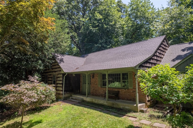 35 Mary Pitkin Path, Shoreham, NY 11786 - view of front facade featuring roof with shingles, a front lawn, a porch, and brick siding