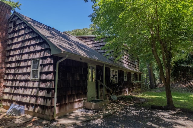 35 Mary Pitkin Path, Shoreham, NY 11786 - view of side of home featuring a chimney and a shingled roof