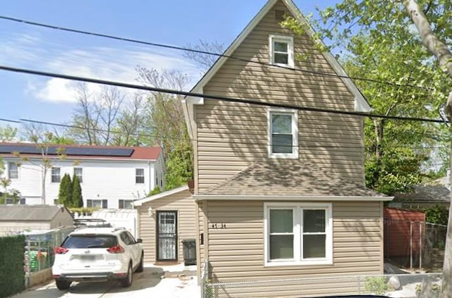 rear view of property with fence