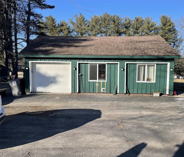 garage featuring aphalt driveway