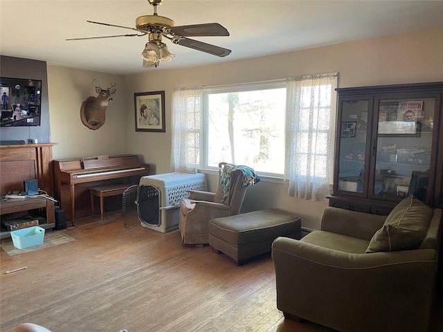 sitting room with ceiling fan and light wood-style floors