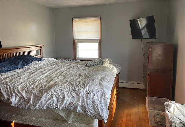 bedroom featuring a baseboard radiator and wood-type flooring