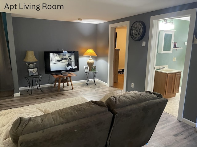 living area with light wood-style floors and baseboards