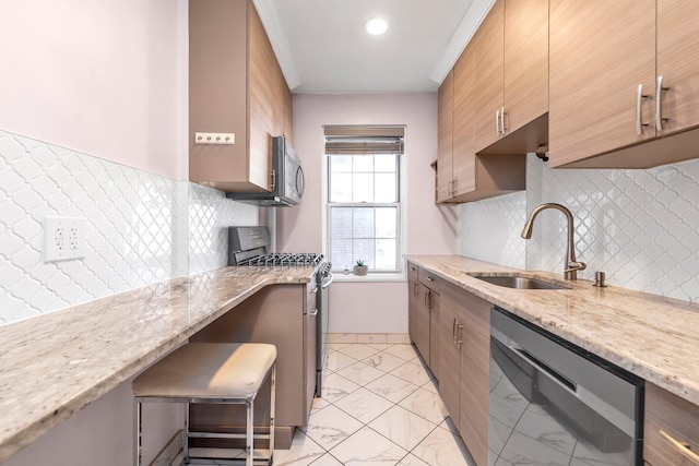 kitchen with appliances with stainless steel finishes, a sink, light stone countertops, marble finish floor, and backsplash