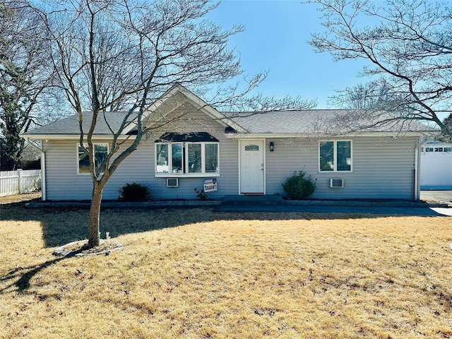 ranch-style home with a front yard and fence