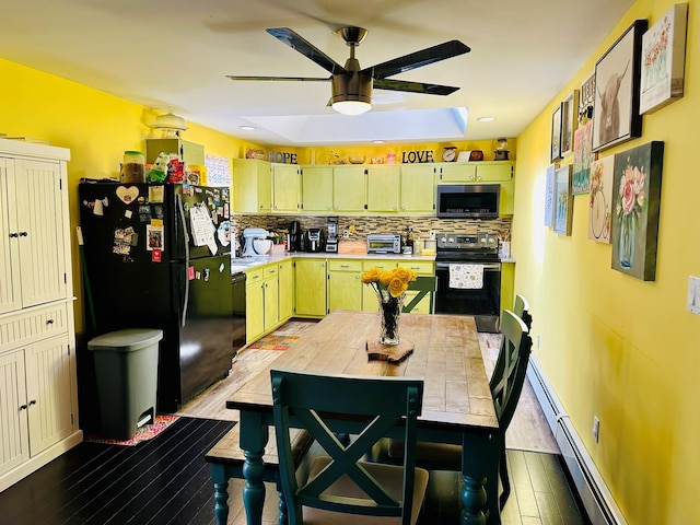 kitchen with wood finished floors, a ceiling fan, light countertops, black appliances, and tasteful backsplash