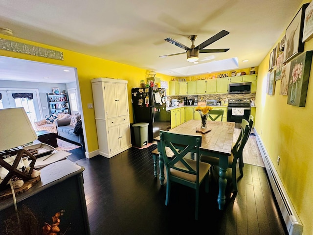 dining room with dark wood-style floors, a baseboard radiator, baseboards, and ceiling fan