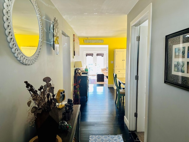 corridor with dark wood-type flooring and french doors