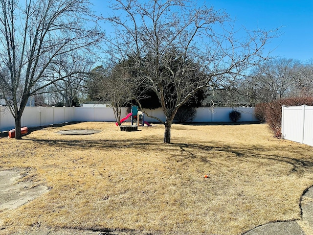 view of yard featuring a playground and a fenced backyard