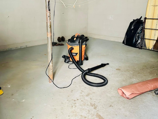 interior details featuring concrete block wall and concrete floors