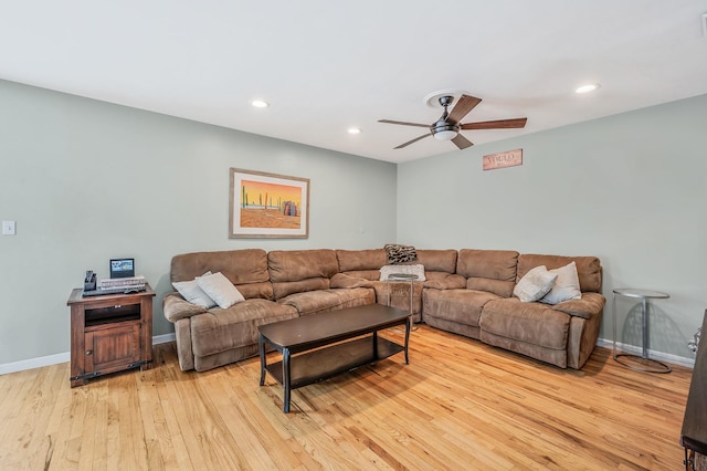 living room with baseboards, a ceiling fan, light wood-style flooring, and recessed lighting