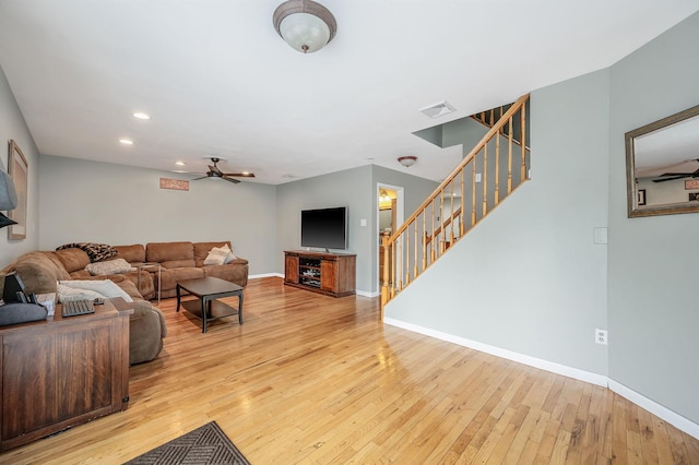 living area with baseboards, visible vents, stairs, light wood-style floors, and recessed lighting