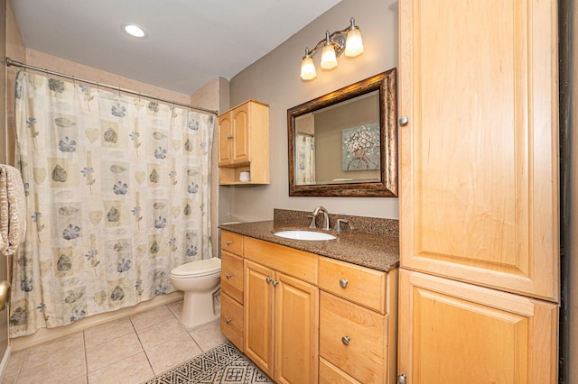 bathroom with toilet, tile patterned flooring, and vanity