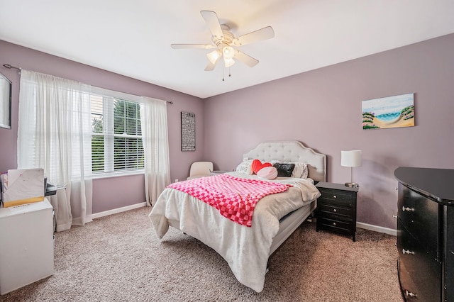 bedroom featuring a ceiling fan, light carpet, and baseboards