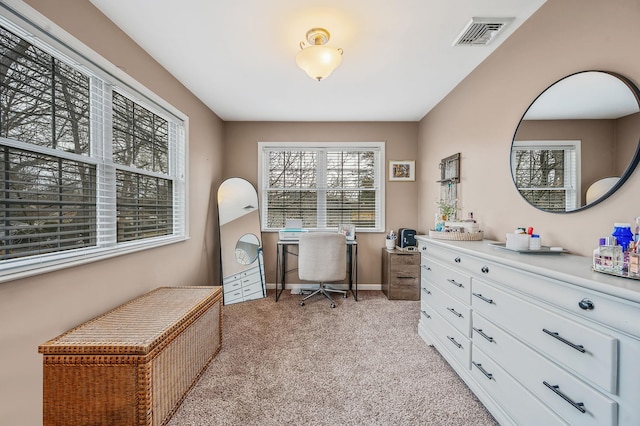 office area with light colored carpet, visible vents, and baseboards