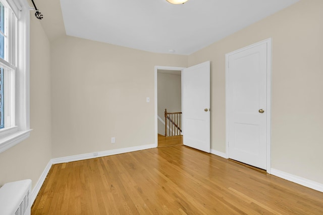 unfurnished bedroom with light wood-style floors and baseboards