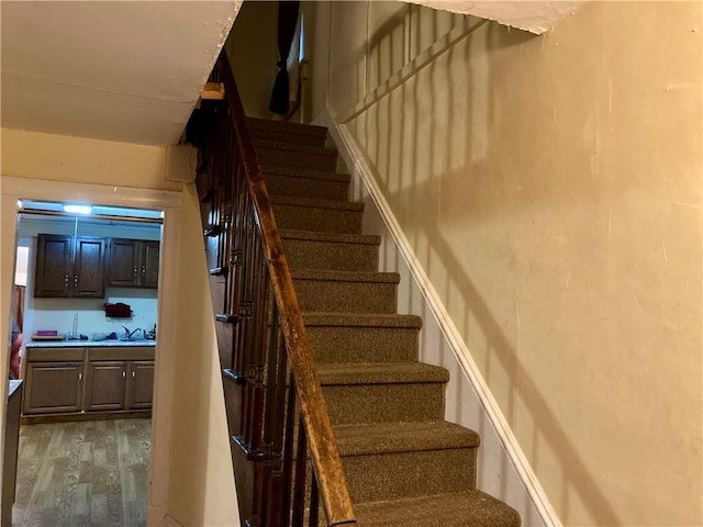 staircase with wood finished floors