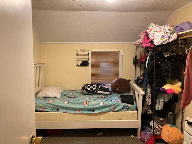 carpeted bedroom with vaulted ceiling and a textured ceiling