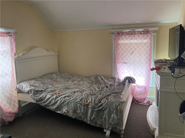 bedroom with vaulted ceiling and carpet