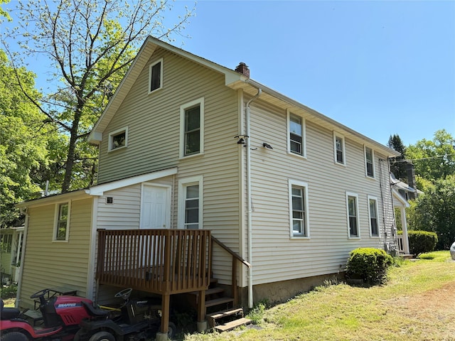 16 Fair St, Highland, NY 12528 - back of property featuring a chimney, a deck, and a lawn