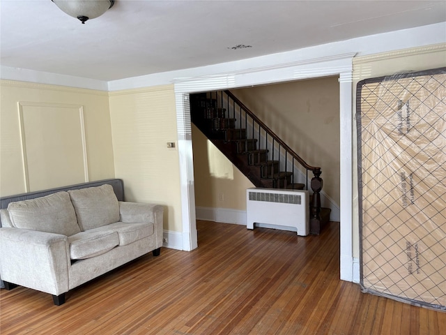16 Fair St, Highland, NY 12528 - sitting room with radiator heating unit, hardwood / wood-style flooring, stairs, and baseboards