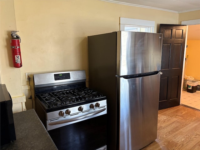 16 Fair St, Highland, NY 12528 - kitchen featuring stainless steel appliances, light wood-style floors, and ornamental molding