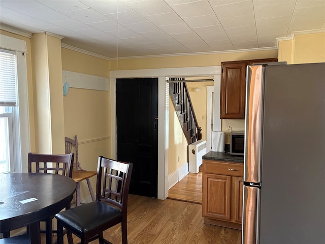16 Fair St, Highland, NY 12528 - dining space with crown molding, wood finished floors, and stairway