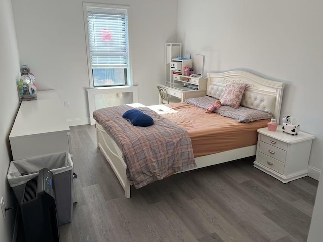 bedroom featuring dark wood-style flooring and baseboards