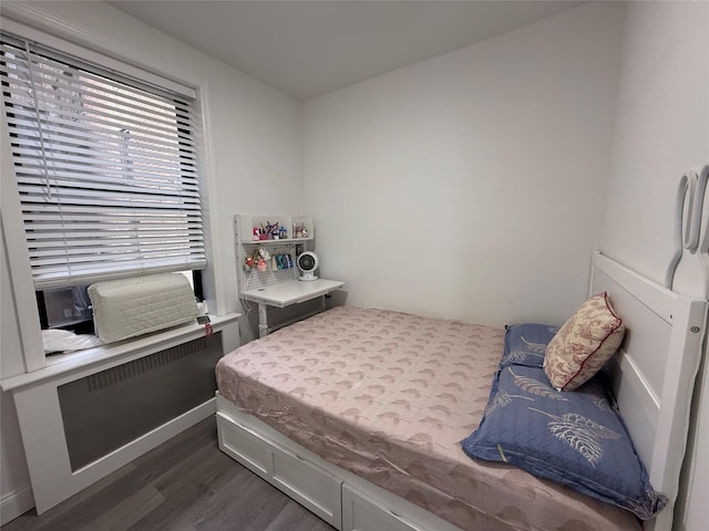 bedroom featuring dark wood finished floors and baseboards