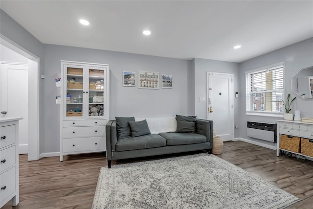 living room with recessed lighting, baseboards, and wood finished floors