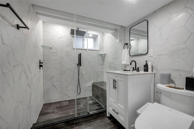 bathroom featuring tile walls, decorative backsplash, toilet, a stall shower, and vanity
