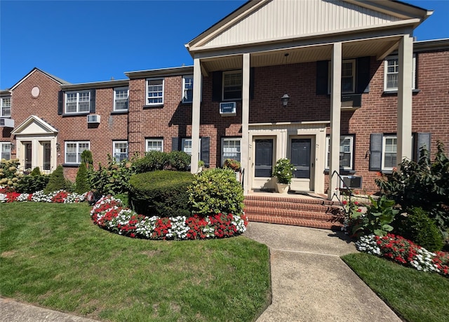 view of front of property with a front yard and brick siding