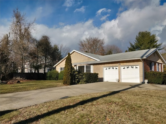 view of home's exterior with a garage, driveway, and a lawn