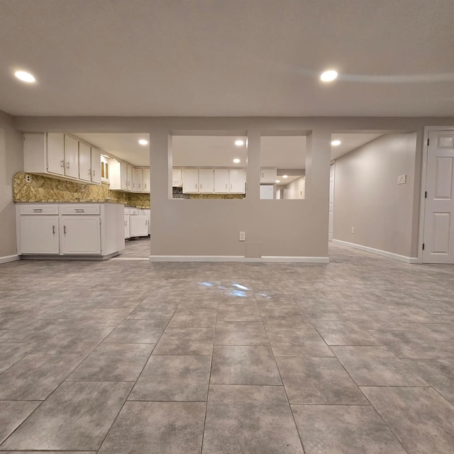 unfurnished living room with light tile patterned floors, recessed lighting, and baseboards