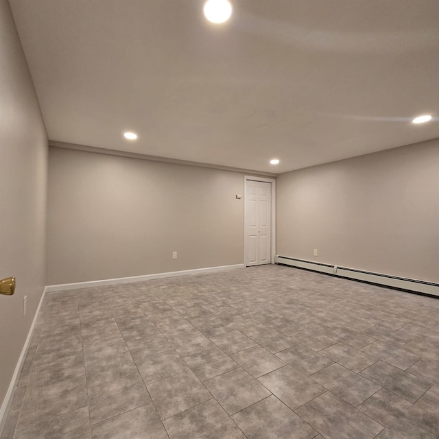 finished basement featuring baseboards, a baseboard radiator, and recessed lighting