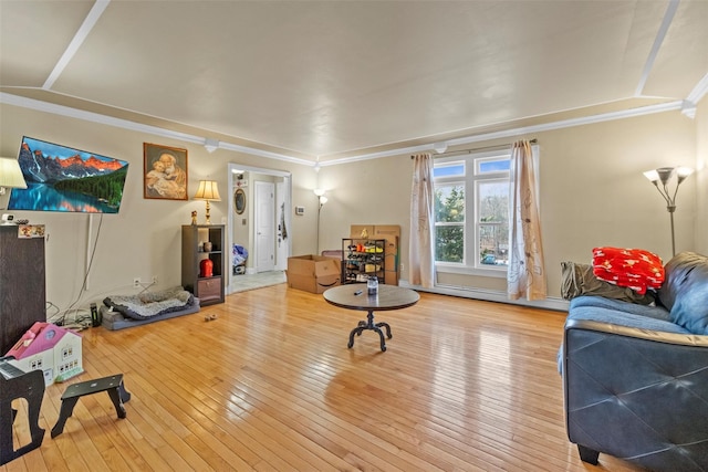 living area with ornamental molding and hardwood / wood-style flooring