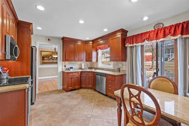 kitchen featuring stainless steel appliances, recessed lighting, light countertops, backsplash, and light tile patterned flooring