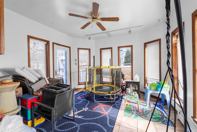 game room with track lighting, a ceiling fan, and tile patterned floors