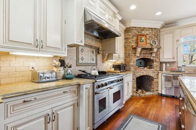 kitchen featuring dark wood finished floors, appliances with stainless steel finishes, crown molding, under cabinet range hood, and backsplash