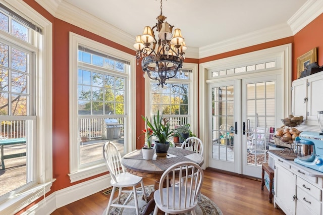 dining area featuring ornamental molding, plenty of natural light, french doors, and dark wood finished floors