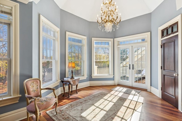 sunroom with a chandelier and french doors